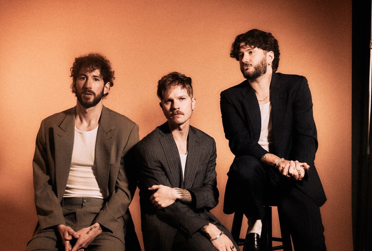 The three members of The Band CAMINO sitting on stools