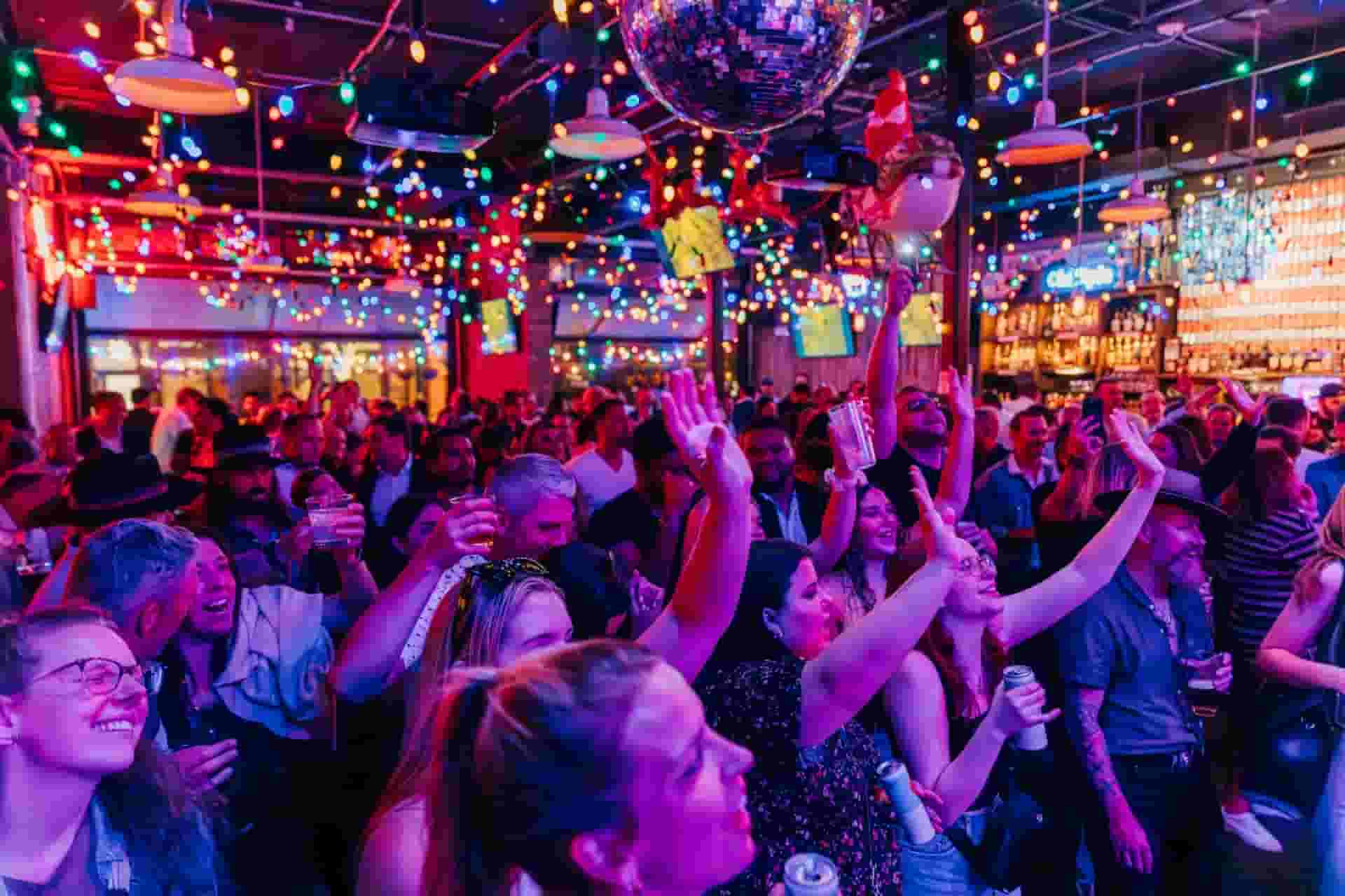 a crowc cheering and dancing