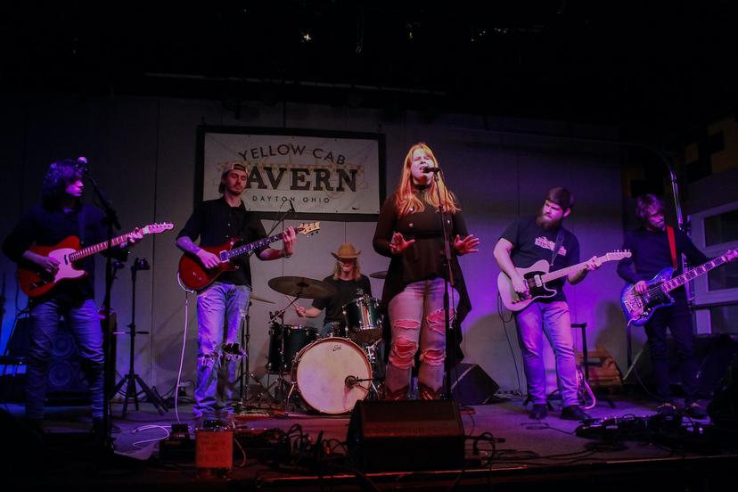 a crowd of people have their phones in their hands with the flashlight on and sing