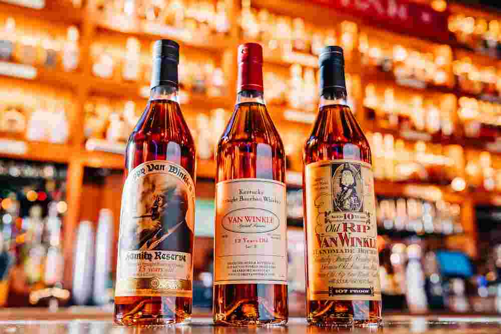 three bottles of pappy van winkle whiskey bottles on the bar at bub city