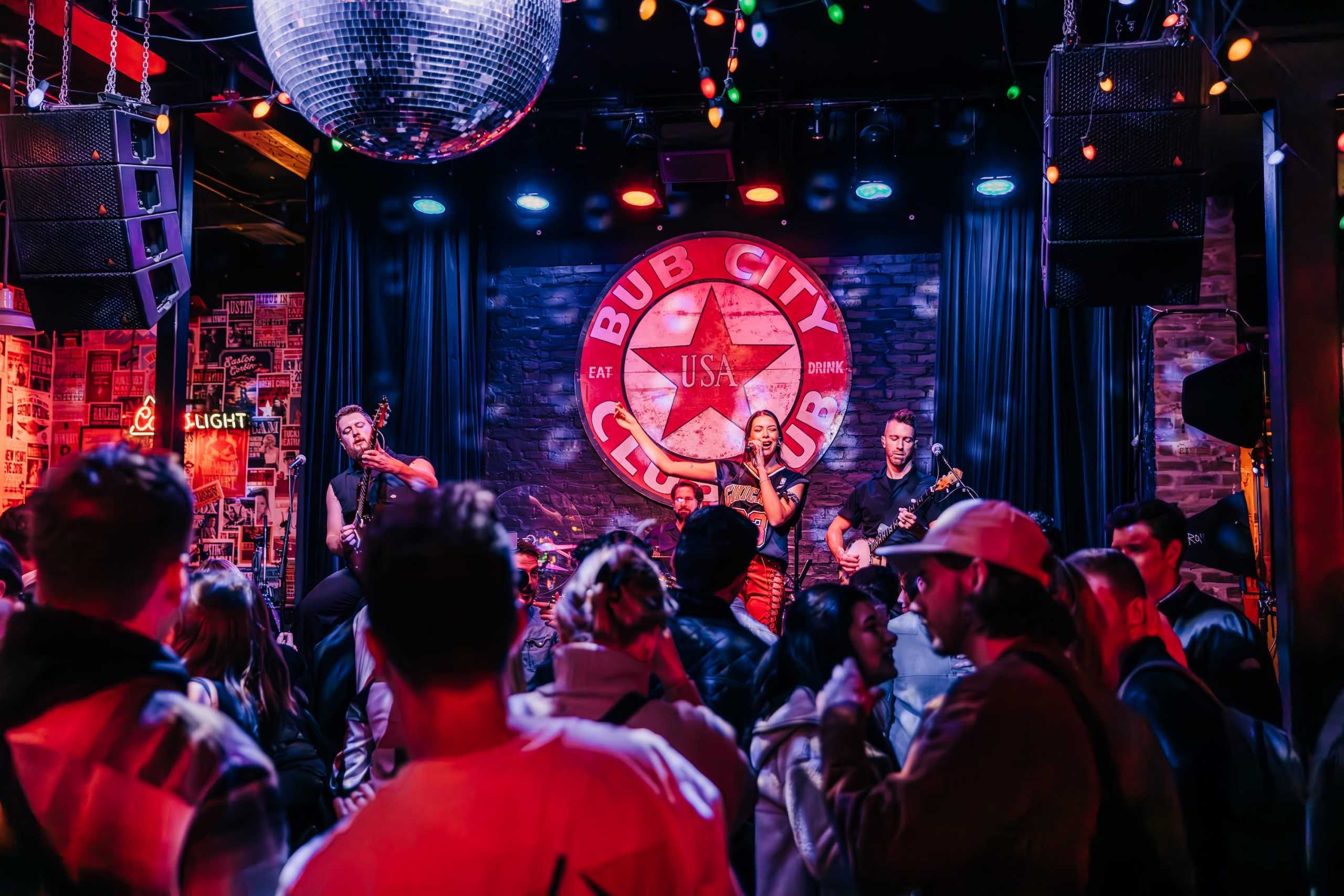 Crowd listening to a band on a stage.
