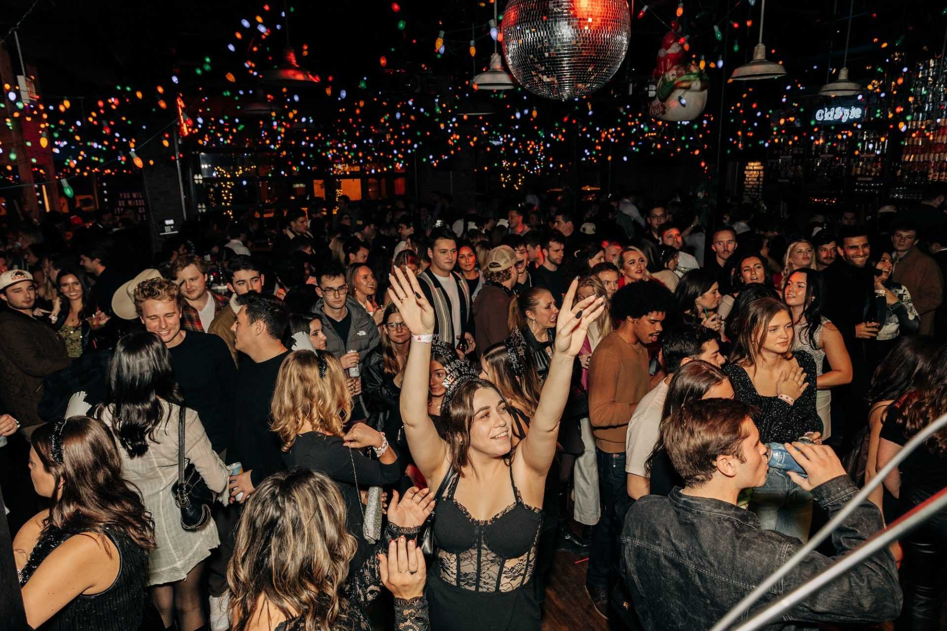 girl with her hands in the air in a crowd