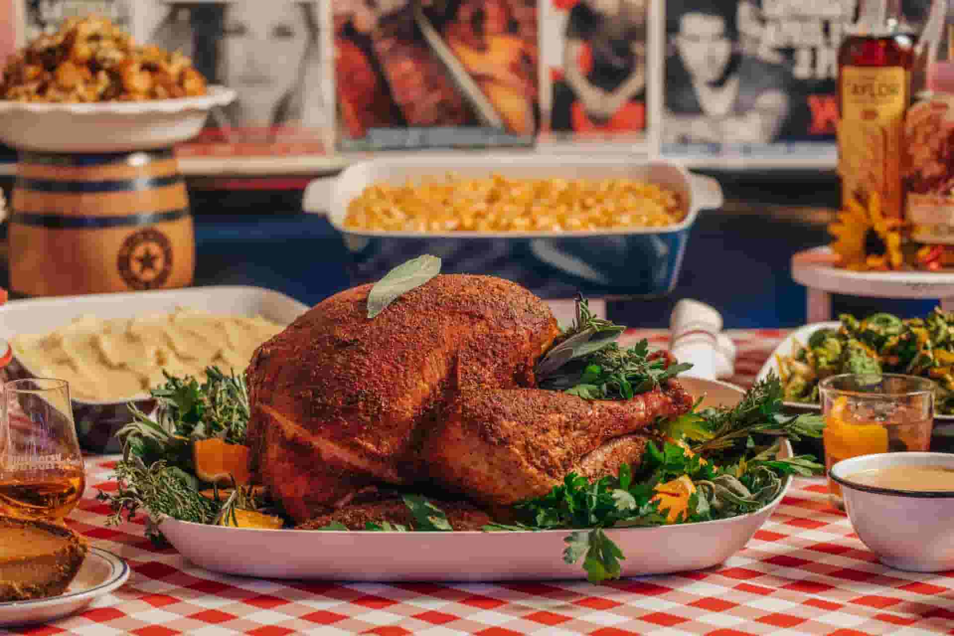 turkey, mashed potatoes and mac 'n cheese on a red and white checkered table cloth