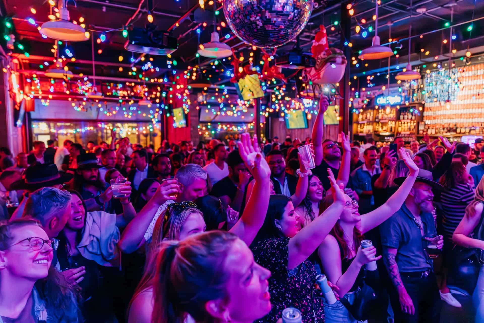 a crowc cheering and dancing